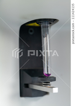Dripping liquid from pipette into test tube in laboratory, closeup Dripping liquid from pipette into test tube in laboratory, closeup 111424135