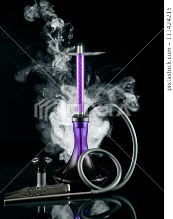 Purple hookah with a flask and tongs on a black background. Artistic shooting in a studio with white smoke and reflection. 111424215