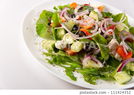Traditional greek salad with fresh ingredients, feta cheese, olives, red tomatoes, cucumbers and greens Traditional greek salad with fresh ingredients, feta cheese, olives, red tomatoes, cucumbers and greens 111424352