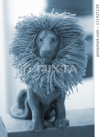 Art object model of lion printed on 3D printer. Lion toy created by 3D printing from molten plastic. Example of creating prototype by 3D printer. Concept 3D printing. Printing innovation technology Art object model of lion printed on 3D printer. Lion toy created by 3D printing from molten plastic. Example of creating prototype by 3D printer. Concept 3D printing. Printing innovation technology 111425139