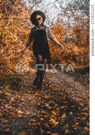 Hipster woman portrait, autumn park, beautiful golden nature. Lifestyle, hat. Hipster woman portrait, autumn park, beautiful golden nature. Lifestyle, hat. 111425225
