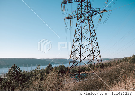 Electrical equipment, high voltage power line insulators on winter sky backdrop. Electrical equipment, high voltage power line insulators on winter sky backdrop. 111425238
