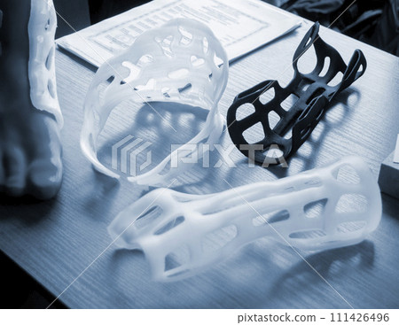 Hand and neck splint corset prosthesis langet printed on a 3D printer from molten plastic. Medical orthosis, fixator, plastic overlay created on 3D printer. New modern medical 3D printing technologies 111426496