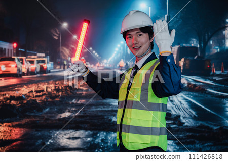 Security guard controlling traffic on the road Security guard controlling traffic on the road 111426818
