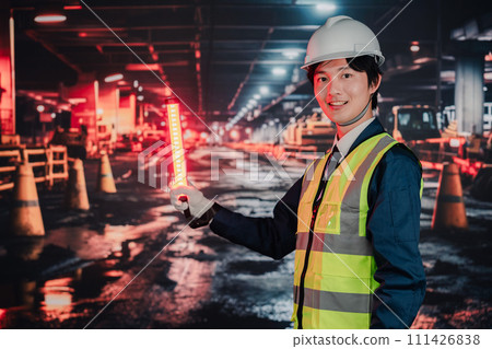 Security guard controlling traffic on the road Security guard controlling traffic on the road 111426838