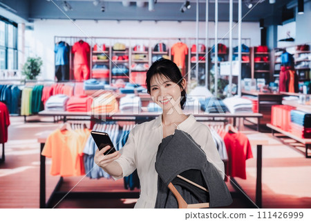 Young woman shopping at a clothing store Young woman shopping at a clothing store 111426999