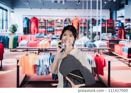 Young woman shopping at a clothing store Young woman shopping at a clothing store 111427000
