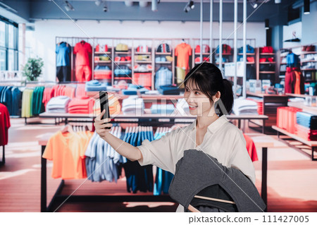 Young woman shopping at a clothing store Young woman shopping at a clothing store 111427005