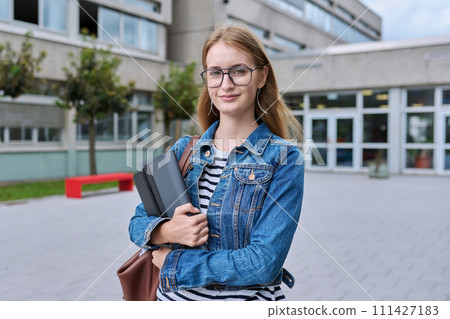Portrait of teenage girl high school student, outdoor near educational building 111427183