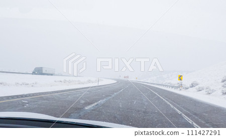 POV-Electric vehicle is captured deftly navigating the I-70 highway during a winter storm in Western Colorado. POV-Electric vehicle is captured deftly navigating the I-70 highway during a winter storm in Western Colorado. 111427291