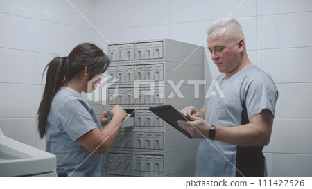 Diverse scientists check samples of tests using digital tablet Diverse scientists check samples of tests using digital tablet 111427526