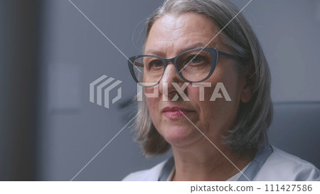 Close up shot of female doctor looking at monitor of sonography machine 111427586