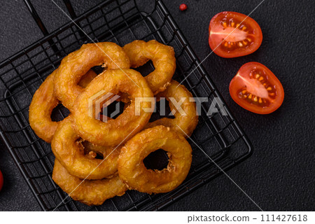Delicious nutritious squid or onion rings deep fried with salt and spices 111427618