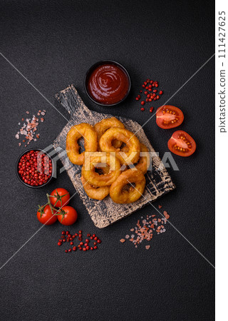 Delicious nutritious squid or onion rings deep fried with salt and spices 111427625
