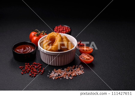 Delicious nutritious squid or onion rings deep fried with salt and spices 111427651