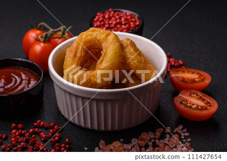 Delicious nutritious squid or onion rings deep fried with salt and spices Delicious nutritious squid or onion rings deep fried with salt and spices 111427654
