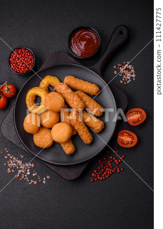Delicious nuggets, rings and balls of mozzarella and parmesan cheese with salt and spices Delicious nuggets, rings and balls of mozzarella and parmesan cheese with salt and spices 111427775