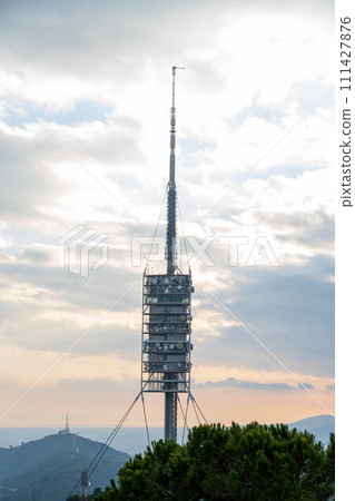 Telecommunications tower on top of the mountain near the city. Tibidabo, Barcelona. Vertical 111427876
