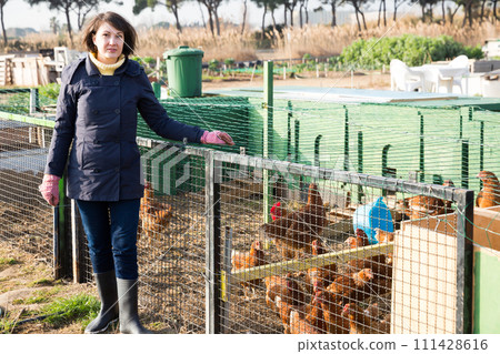 Girl farmer caring for poultry 111428616