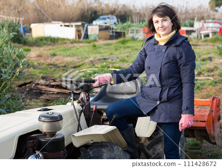 Female farmer at tractor 111428672
