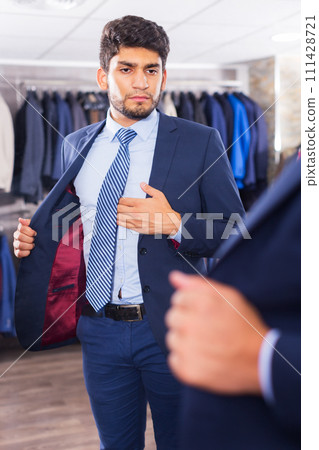 Man trying on jacket 111428721