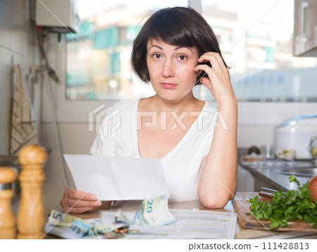 Woman counting money for paying bills 111428813