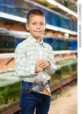 Preteen boy with goldfish Preteen boy with goldfish 111429663