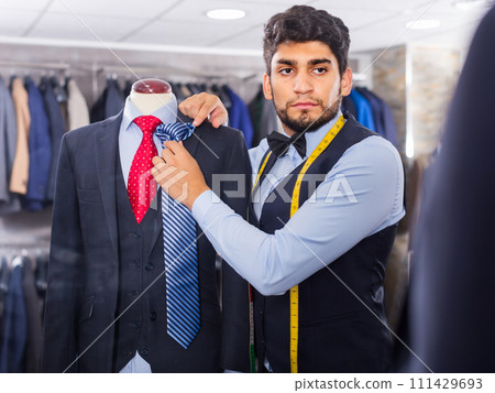 Fashion designer is picking up a tie to business image 111429693