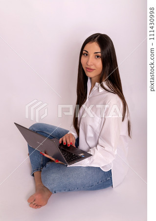 Young woman using laptop in hands on white background. Remote work online Young woman using laptop in hands on white background. Remote work online 111430998