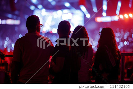 Silhouettes of people at a concert in front of the stage Silhouettes of people at a concert in front of the stage 111432105