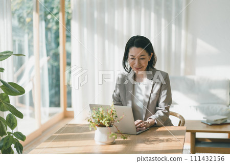Middle-aged woman teleworking at home 111432156
