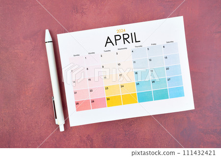 April 2024 calendar page and pen on red retro background. April 2024 calendar page and pen on red retro background. 111432421