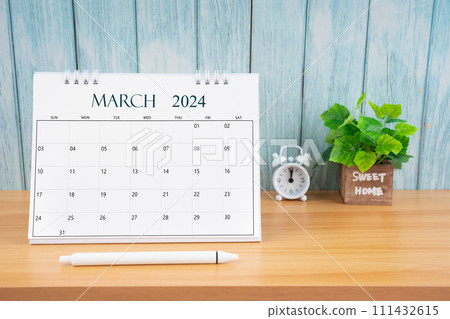 March Monthly desk calendar for 2024 year and alarm clock. 111432615