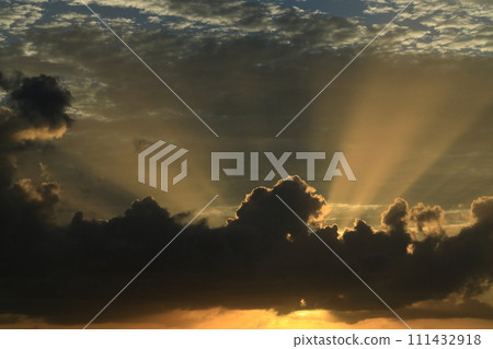 Nature landscape, rays of light, upward rays of light from the sun hidden behind the clouds. The sky is blue overhead, the sun is in the clouds Nature landscape, rays of light, upward rays of light from the sun hidden behind the clouds. The sky is blue overhead, the sun is in the clouds 111432918