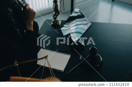 Judge gavel with Justice lawyers having team meeting at law firm background. Concepts of Law and Legal services. 111432919