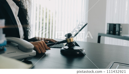 Judge gavel with Justice lawyers having team meeting at law firm background. Concepts of Law and Legal services. 111432921