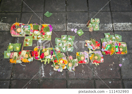 Group of sacrifice oblation offerings for Gods and spiritual in Hinduism on the street of Ubud market in Bali, Indonesia. 111432993