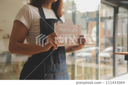 Startup successful small business owner sme beauty girl stand with tablet smartphone in coffee shop restaurant. Portrait of asian tan woman barista cafe owner. SME entrepreneur seller business concept Startup successful small business owner sme beauty girl stand with tablet smartphone in coffee shop restaurant. Portrait of asian tan woman barista cafe owner. SME entrepreneur seller business concept 111433064