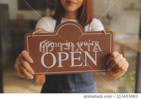 Startup successful small business owner sme beauty girl stand with tablet smartphone in coffee shop restaurant. Portrait of asian tan woman barista cafe owner. SME entrepreneur seller business concept 111433065