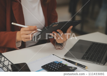 Shot of a asian young business Female working on laptop in her workstation. 111433091