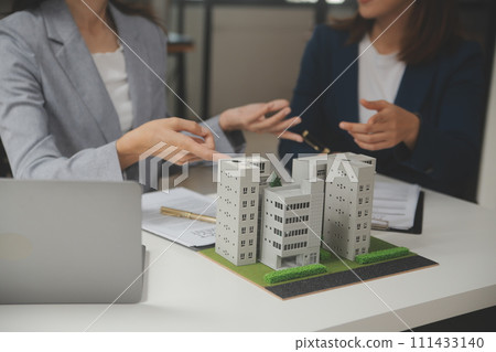 Business Signing a Contract Buy - sell house, insurance agent analyzing about home investment loan Real Estate concept. 111433140