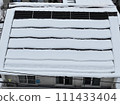 Snowfall and solar panels on the roof 111433404