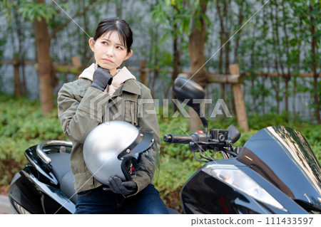 A woman who is worried while riding a bike 111433597