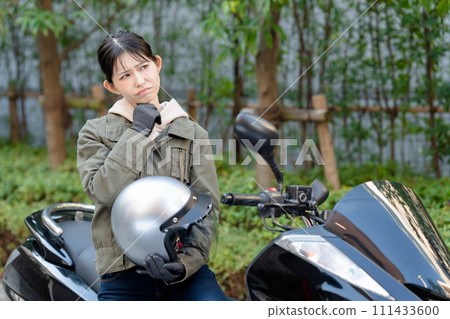 A woman who is worried while riding a bike A woman who is worried while riding a bike 111433600