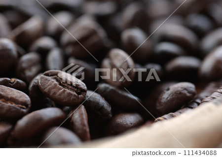 Coffee beans in a hand-woven colander Coffee beans in a hand-woven colander 111434088