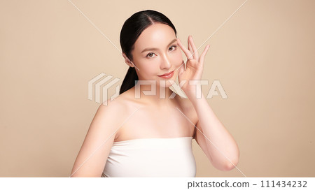 Beautiful young asian woman with clean fresh skin on beige background, Face care, Facial treatment, Cosmetology, beauty and spa, Asian women portrait. 111434232