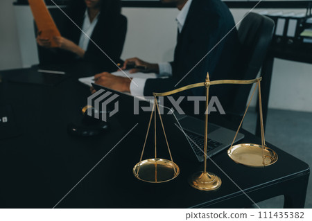 Judge gavel with Justice lawyers having team meeting at law firm background. Concepts of Law and Legal services. 111435382