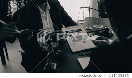 Judge gavel with Justice lawyers having team meeting at law firm background. Concepts of Law and Legal services. 111435385