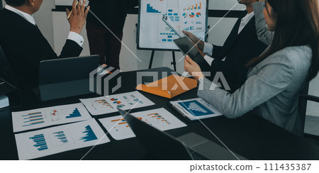Business team collaboration discussing working analyzing with financial data and marketing growth report graph in team, presentation and brainstorming to strategy planning making profit of company. Business team collaboration discussing working analyzing with financial data and marketing growth report graph in team, presentation and brainstorming to strategy planning making profit of company. 111435387