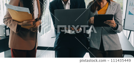 Co working conference, Business team meeting present, investor colleagues discussing new plan financial graph data on office table with laptop and digital tablet, Finance, accounting, investment. Co working conference, Business team meeting present, investor colleagues discussing new plan financial graph data on office table with laptop and digital tablet, Finance, accounting, investment. 111435449